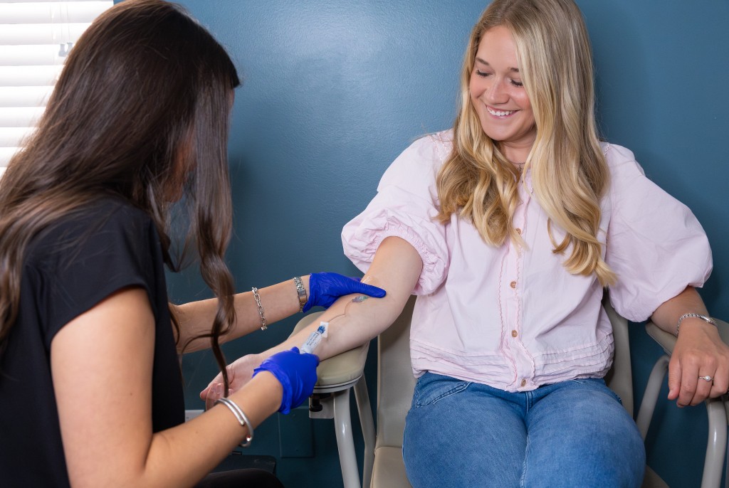 Caroline Marshall, RN preparing an IV infusion at Elevated Health Augusta